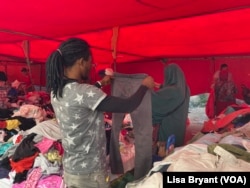 Africans and Tunisians check out second-hand clothes at a Sunday market in the Tunis suburb of La Marsa.