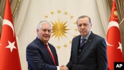 U.S. Secretary of State Rex Tillerson (left) poses with Turkey's President Recep Tayyip Erdogan before their meeting in Ankara, Turkey, March 30, 2017.