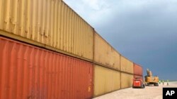 FILE - This photo provided by the Arizona Governor's Office shows shipping containers that will be used to fill a 305-meter gap in the border wall with Mexico near Yuma, Ariz., on Aug. 12, 2022.