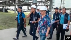 In this handout photo taken from video released by Russian Defense Ministry Press Service on Sept. 2, 2022, International Atomic Energy Agency (IAEA) director Rafael Grossi, center, and IAEA members walk while inspecting the Zaporizhzhia nuclear power pla