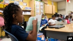A third-grade student reads to the rest of her class at Beecher Hills Elementary School on Aug. 19, 2022, in Atlanta. 