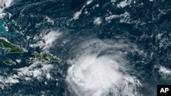 This satellite image provided by NOAA shows Tropical Storm Fiona in the Caribbean, Sept. 17, 2022.