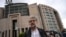 FILE - Erol Onderoglu, Reporters Without Borders (RSF) representative in Turkey, speaks to the press in front of Istanbul's courthouse before his trial on charges of making terror propaganda for Kurdish militants, Sept. 30, 2021. 