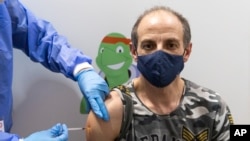 A person gets vaccinated against the COVID-19 virus as the compulsory COVID-19 vaccination starts in Vienna, Austria, Feb. 4, 2022. 