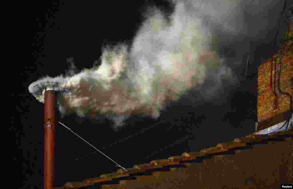 White smoke rising from the chimney on the Sistine Chapel, indicating that a new pope has been elected. 