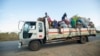 FILE - Displaced families from the community of Impire in the Cabo Delgado province travel on a flatbed truck as they flee on June 14, 2022, from armed insurgents who attacked their community two days earlier. 