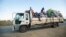 FILE - Displaced families from the community of Impire in the Cabo Delgado province are seen traveling on June 14, 2022, on a flatbed truck as they flee armed insurgents who attacked their community two days earlier. 