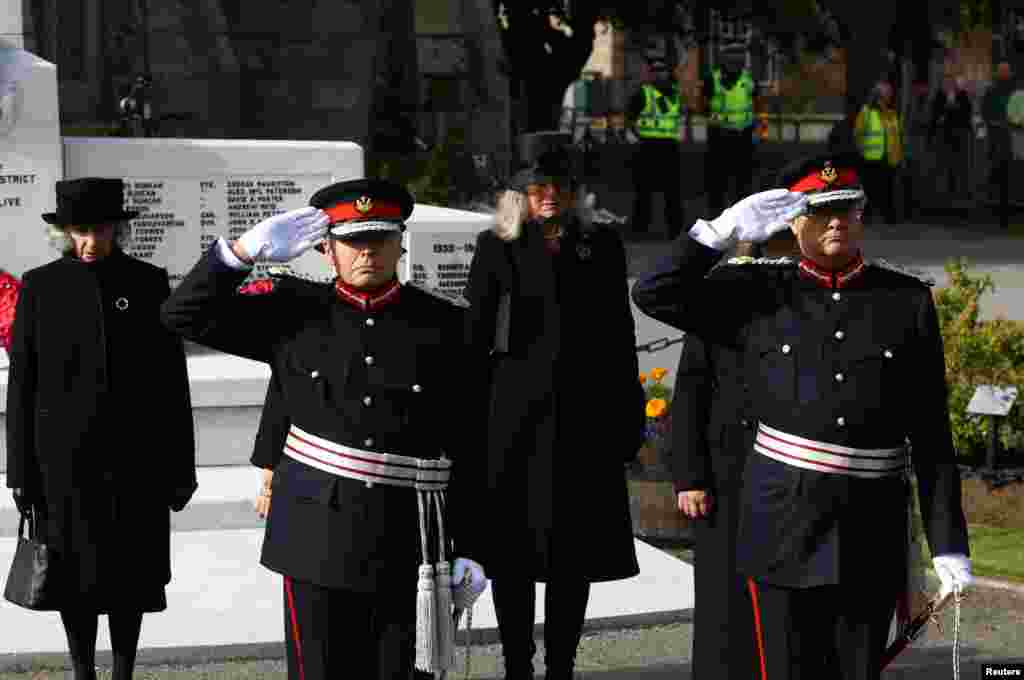 Lord-lieutenants salute as the hearse carrying the coffin of Britain's Queen Elizabeth passes through the village of Ballater, near Balmoral, Sept. 11, 2022.