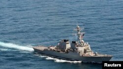 FILE - The guided-missile destroyer USS John S. McCain sails in formation during exercise Foal Eagle 2013 in waters west of the Korean peninsula in this March 21, 2013 handout photo courtesy of the U.S. Navy. 