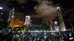Protesters wave their mobile phones during a rally, after China's legislature has ruled out open nominations in elections for Hong Kong's leader in Hong Kong, Aug. 31, 2014.