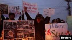 Members of the Hazara community and various non-governmental organizations sit-in during a protest against the twin bomb attack in Quetta, in Lahore, Pakistan, January 12, 2013. 