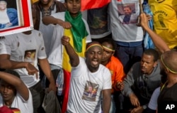 Ethiopians rally in solidarity with Prime Minister Abiy Ahmed, whose photo is seen on a participant’s T-shirt, in Meskel Square in the capital, Addis Ababa, Ethiopia, June 23, 2018.