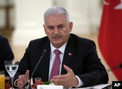 FILE - Turkish Prime Minister Binali Yildirim speaks during a meeting with representatives of German companies, in Ankara, Turkey, July 27, 2017.