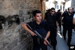 FILE - Turkish police officers conduct a security operation in Diyarbakir, southeastern Turkey, Aug. 15, 2015.