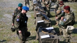 Servicemen from Poland inspect the weapons of Ukrainian paratroopers during a large military exercise called "Three Swords-2021" involving more than 1,200 servicemen and more than 200 combat vehicles from Ukraine, U.S., Poland and Lithuania, at Yavoriv training ground in Lviv region, Ukraine, July 27, 2021.