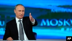 FILE - Russian President Vladimir Putin gestures as he answers a question during his annual call-in show in Moscow, April 14, 2016.