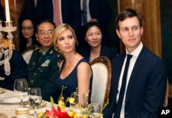 FILE - Ivanka Trump, center, the daughter and assistant to President Donald Trump, is seated with her husband, White House senior adviser Jared Kushner, right, during a dinner with President Donald Trump and Chinese President Xi Jinping at Trump's Mar-a-Lago estate in Florida, April 6, 2017.