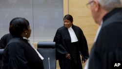 FILE - Prosecutor Fatou Bensouda (C) arrives for a hearing at the ICC in The Hague, Netherlands, Oct. 8, 2014. Bensouda announced in April she was opening a preliminary investigation into allegedly serious crimes being committed in Burundi.