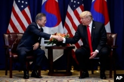 President Donald Trump shakes hands with South Korean President Moon Jae-In at the Lotte New York Palace hotel during the United Nations General Assembly, Sept. 24, 2018, in New York.