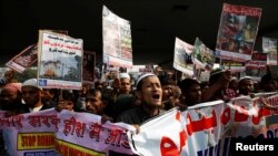 FILE - Rohingya Muslim refugees shout slogans during a protest against what organizers say is the crackdown on ethnic Rohingyas in Myanmar, in New Delhi, India, Dec. 19, 2016.