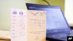 In this photo taken on Friday, Nov. 16 2018 in Tallinn, Estonia, a card shows all the details to register the birth of new baby Oskar Lunde. (AP Photo/David Keyton)