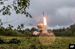 FILE - This undated file photo provided by Russian Defense Ministry official website Sept. 19, 2017, shows a Russian Iskander-K missile launched during a military exercise at a training ground at the Luzhsky Range, near St. Petersburg, Russia.