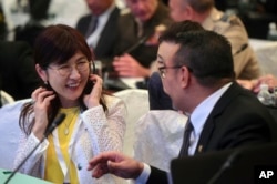 Japan's Defense Minister Tomomi Inada (left) talks with her Malaysian counterpart, Hishammuddin Hussein, ahead of the first plenary session at the 2017 International Institute for Strategic Studies (IISS) Shangri-la Dialogue, an annual defense and security forum in Asia, Saturday, June 3, 2017 in Singapore.