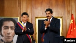 FILE - China's President Xi Jinping, left, claps with his Venezuelan counterpart Nicolas Maduro at Miraflores Palace in Caracas, Venezuela, July 20, 2014. China endorsed Maduro in his most recent election.
