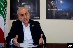 Lebanese Minister of State for Refugee Affairs, Mouin Merhebi, speaks during an interview with the Associated Press, at his office, in Beirut, Lebanon, Nov. 27, 2018.