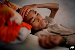 FILE - A patient in the advanced stages of AIDS, lays in his bed at the Mai Hoa Center for HIV and AIDS patients in the village of An Nhon Tay, 60 kilometers, (37 miles) northwest of Ho Chi Minh City, Vietnam, Oct. 10, 2009.