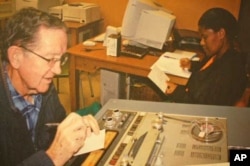 Ethnomusicologist Andrew Tracey (left) taking notes about one of his father’s, Hugh Tracey’s, tape recordings at the International Library of African Music