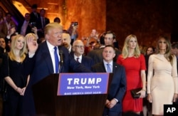 Surrounded by family and supporters, Republican presidential candidate Donald Trump speaks during a New York state primary campaign event in New York City, April 19, 2016.