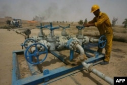 FILE - An Iraqi worker checks the valves at the Kirkuk oil field on June 29, 2009, 225 kms from Baghdad.