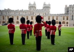 Royal Guardsman look out from the Quadrangle of Windsor Castle after President Barack Obama and first lady Michelle Obama arrived at Windsor Castle in Windsor, England, April 22, 2016.