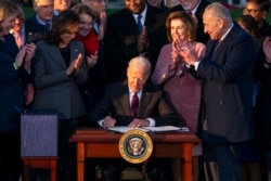 President Joe Biden signs the "Infrastructure Investment and Jobs Act" during an event on the South Lawn of the White House, Nov. 15, 2021.