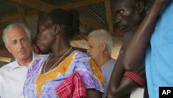U.S. Sen. Bob Corker, left, speaks with a woman who has recently arrived from South Sudan, at a registration center in northern Uganda for South Sudanese refugees, April 14, 2017.
