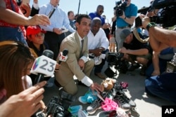 Miami Mayor Francis Suarez, left, and Columbia, South Carolina Mayor Steve Benjamin explain to the media the symbolic gesture of bringing shoes as gifts for immigrant children that are being held at a facility in Tornillo, Texas, June 21, 2018.
