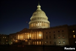 FILE - The U.S. Capitol Building is lit at sunset in Washington, Dec. 20, 2016.