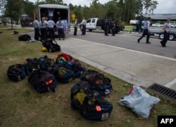 Members of the Missouri Search and Rescue, part of FEMA, unload their gear at a staging area as Hurricane Florence starts to make landfall in Lealand, North Carolina, Sept. 13, 2018.