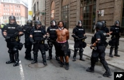 Police escort away a counterprotester near a "Free Speech" rally staged by conservative activists, Aug. 19, 2017, in Boston.