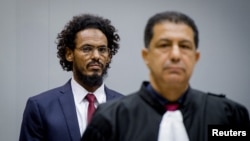 Ahmad Al Faqi Al Mahdi enters the courtroom of the International Criminal Court in the Netherlands