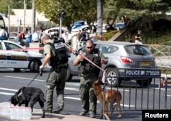 FILE - Israeli police secure the area following a shooting incident that an Israeli police spokesperson described as a terrorist attack, near police headquarters in Jerusalem, Oct. 9, 2016.