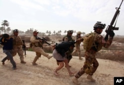 FILE - Iraqi security forces arrest suspected Islamic State militants in Jurf-al-Sakhar, 60 km (40 miles) from the capital Baghdad, Feb. 15, 2014.
