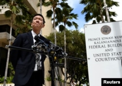 FILE - Hawaii Attorney General Douglas Chin answers questions from the media at the U.S. District Court Ninth Circuit after presenting his arguments after filing an amended lawsuit against President Donald Trump's new travel ban in Honolulu, Hawaii, March 15, 2017.