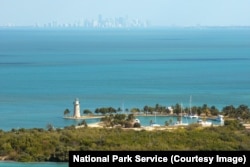 The lighthouse on Boca Chita Key, with a view of the Miami Skyline