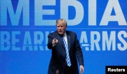 FILE - U.S. President Donald Trump gestures after speaking at a National Rifle Association convention in Dallas, Texas, May 4, 2018.