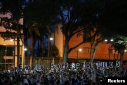 People hold placards at a rally honoring victims of violence in protests against Venezuelan President Nicolas Maduro's government, in Caracas, Aug. 30, 2017.