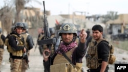 Members of Iraq's elite counter-terrorism service secure the central Ramadi’s Hoz neighborhood after Islamic State jihadists abandon their last stronghold in the Anbar province capital, Dec. 27, 2015.