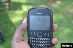 Community health volunteers in Emulsala village, in Western Kenya's Kakamega County, use mobile phones to report serious malaria cases to better equipped clinics and hospitals, July 19, 2017.