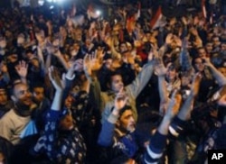 Egyptian citizens celebrate after President Hosni Mubarak resigned and handed power to the military at Tahrir Square, in Cairo, February 11, 2011